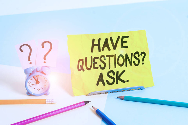 Text sign showing Have Questionsquestion Ask. Conceptual photo something that you say or write to ask a demonstrating Mini size alarm clock beside stationary placed tilted on pastel backdrop. - Photo, Image