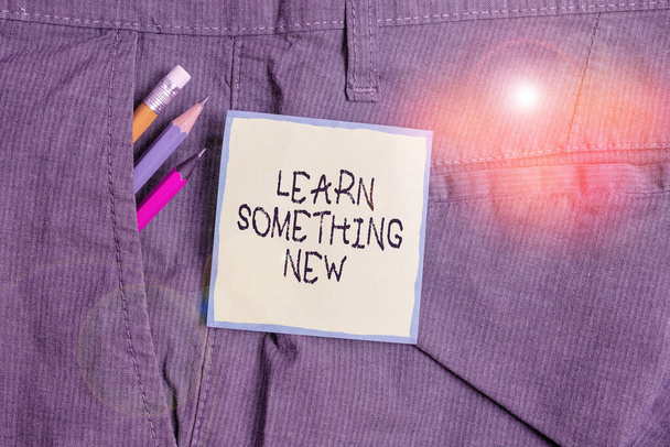 Text sign showing Learn Something New. Conceptual photo being taught new subject activity Knowledge or sport Writing equipment and green note paper inside pocket of man work trousers. - Photo, Image