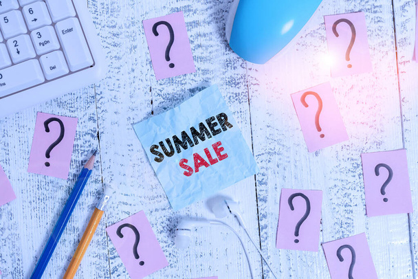 Writing note showing Summer Sale. Business photo showcasing time when a store sells products at much lower prices than usual Writing tools and scribbled paper on top of the wooden table. - Photo, Image