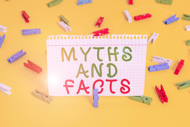Handwriting text Myths And Facts. Concept meaning Oppositive concept about modern and ancient period Colored clothespin papers empty reminder yellow floor background office. - Photo, Image