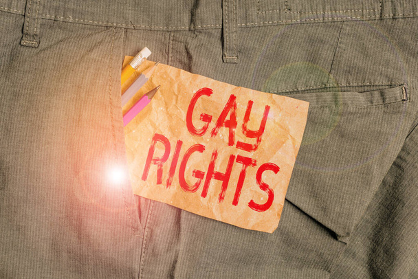 Word writing text Gay Rights. Business concept for equal civil and social rights for homosexuals individuals Writing equipment and brown note paper inside pocket of man work trousers. - Photo, Image