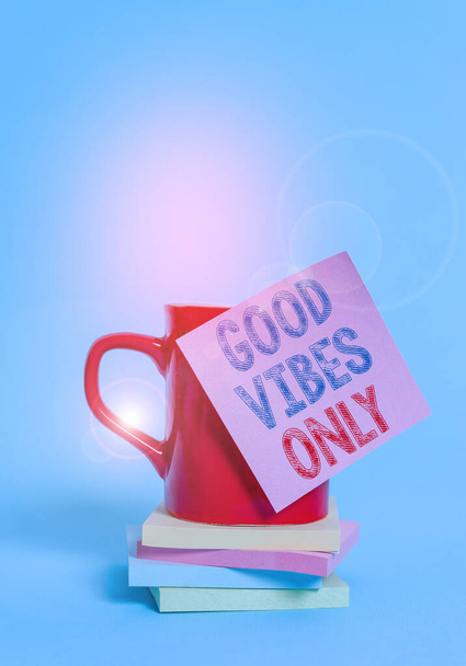 Conceptual hand writing showing Good Vibes Only. Business photo showcasing Just positive emotions feelings No negative energies Coffee cup colored sticky note stacked pads plain background. - Photo, Image