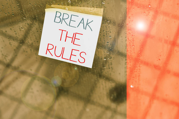 Writing note showing Break The Rules. Business photo showcasing Make changes do everything different Rebellion Reform Square paper piece notation stick to textured glass window. - Photo, Image
