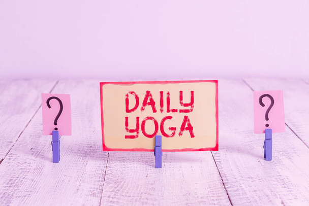 Text sign showing Daily Yoga. Conceptual photo series of Yoga workouts to train different parts of your body Scribbled and crumbling sheet with paper clips placed on the wooden table. - Foto, Bild