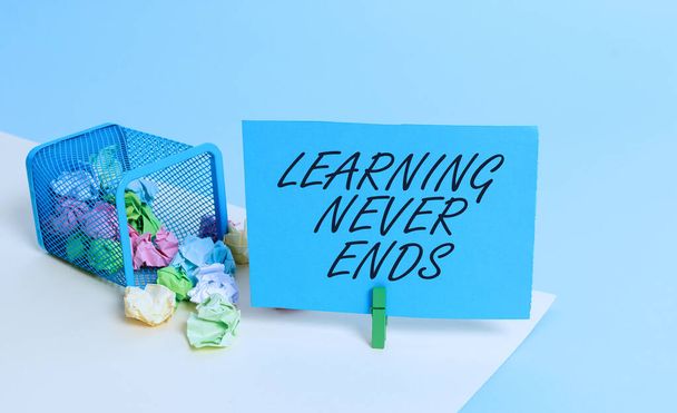 Writing note showing Learning Never Ends. Business photo showcasing Life Long Educational and Wellness Opportunities Trash bin crumpled paper clothespin reminder office supplies. - Photo, Image