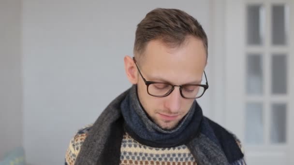 Sick young European man in a scarf is taking an antibiotic. - Felvétel, videó