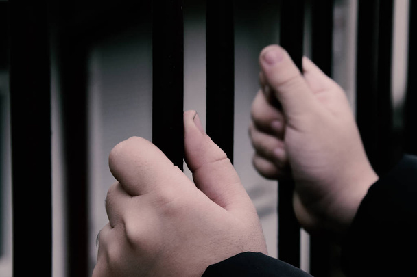 Child hands on a prison railing - Photo, Image