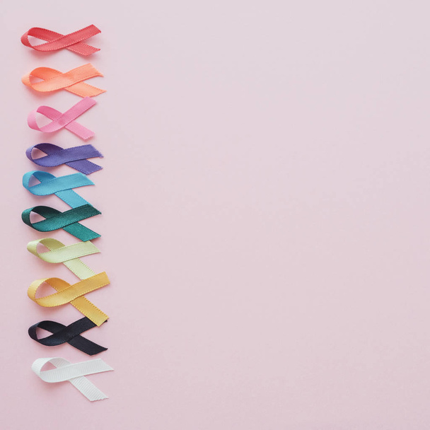 colorful ribbons on pink background, cancer awareness, World can - Foto, immagini