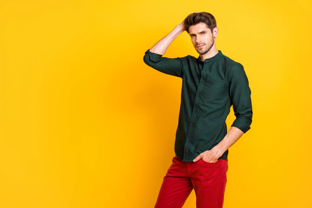 Portrait of gorgeous man rich wealthy businessman attract girls touch his hair after anti dander effect shampoo form hairdresser wear green shirt red pants trousers isolated yellow color background - Fotografie, Obrázek
