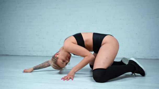 Attractive blonde woman twerking on floor - Кадри, відео