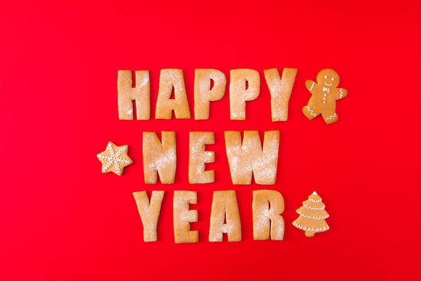 High angle view photo of three baked newyear congrats words with decorative elements figures sweet yummy x-mas composition isolated on bright red background - Foto, Bild