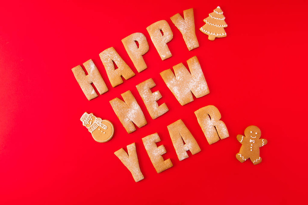 Greeting festive card concept. High angle view photo of three baked words elements figures tasty sweet congratulation x-mas composition made red background - Photo, Image