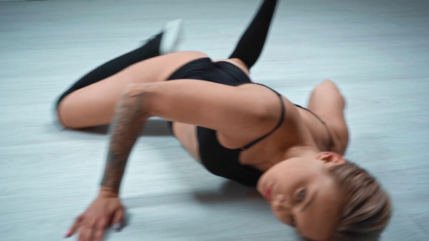 Beautiful woman dancing twerk on floor - Кадры, видео