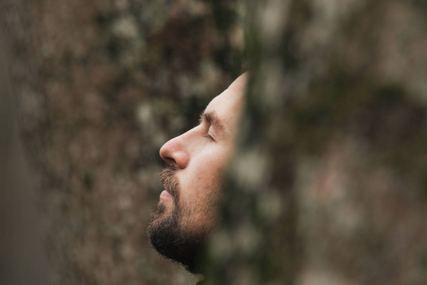 Portrait of a man close-up in the woods. The unity of man and nature. Man and trees, - Fotoğraf, Görsel
