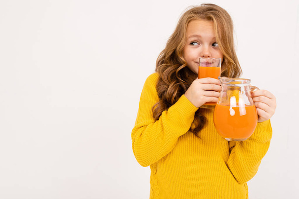 cute girl posing with juice in studio on light background  - Photo, Image