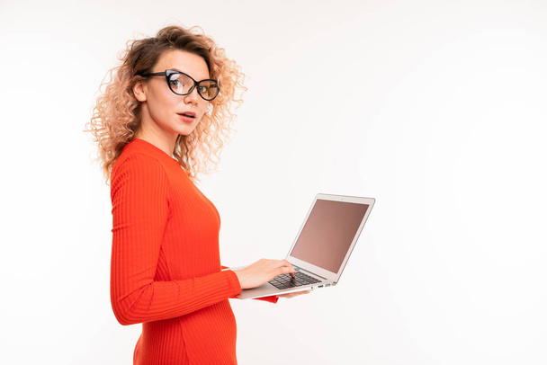 young woman in red dress posing with laptop against white background   - Photo, Image