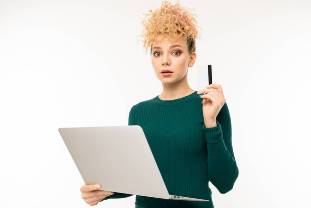 young woman in green dress posing with laptop against white background   - Photo, Image