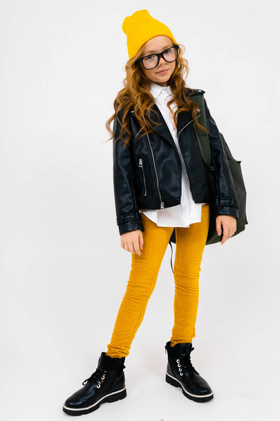 cute fashionable little girl in leather jacket with backpack - Foto, imagen