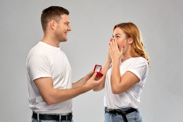 man giving woman engagement ring on valentines day - Valokuva, kuva