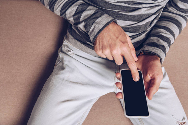 cropped view of man using smartphone with blank screen  - Фото, зображення