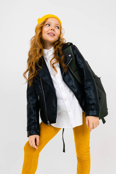 cute fashionable little girl in leather jacket with backpack - Foto, afbeelding