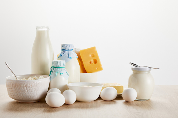 delicious organic dairy products and eggs on wooden table isolated on white - Foto, Imagem