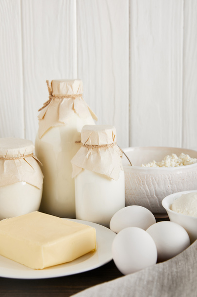 delicious fresh dairy products and eggs on white wooden background - 写真・画像