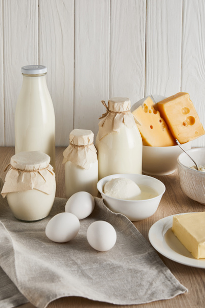 delicious fresh dairy products and eggs on white wooden background - Foto, Bild