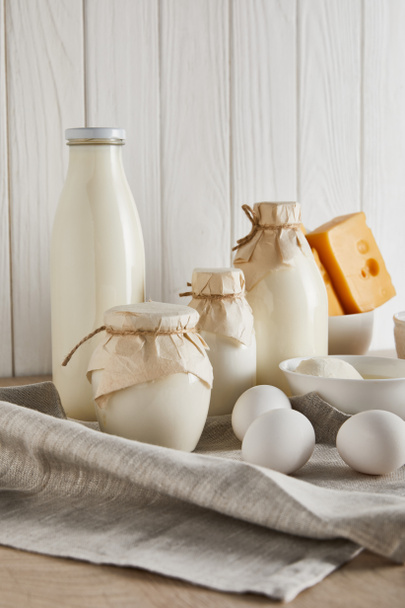 delicious fresh dairy products and eggs on white wooden background - Fotoğraf, Görsel