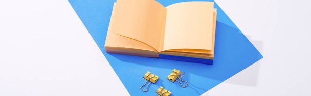 panoramic shot of notebook, binder clips and paper on white background  - 写真・画像