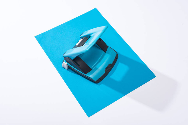 high angle view of holepunch and colorful paper on white background  - 写真・画像