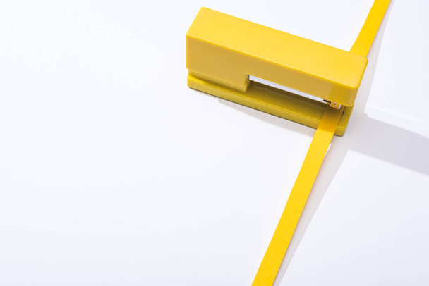 high angle view of stapler and paper strip on white background  - Photo, Image