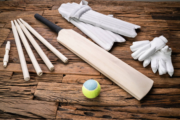 Elevated View Of Cricket Accessories And Tools On Brown Textured Backdrop - Foto, Imagen