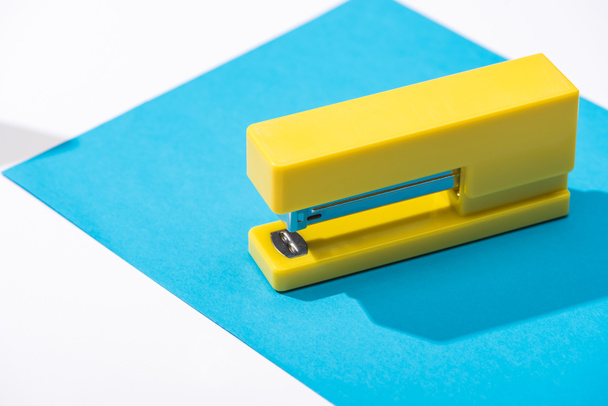 high angle view of stapler and paper on white background  - Photo, image