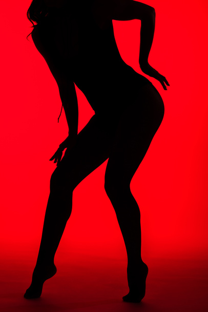 black silhouette of sensual girl on red - Photo, Image