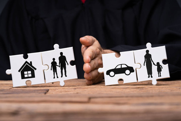 Jigsaw Puzzles Showing Separation Of Family With House And Car Divided By Person's Hand - Foto, Imagem
