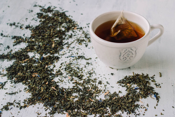 Φυτικό φλιτζάνι τσάι με το φυτό γύρω - Φωτογραφία, εικόνα