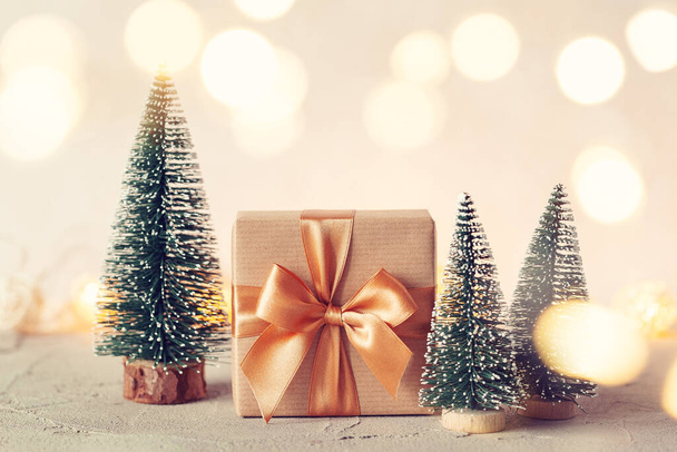 Christmas Composition with present box and christmas tree on neutral background. Holiday greeting card. - Photo, Image