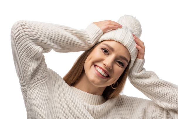 attractive smiling woman posing in white knitted sweater and hat, isolated on white - Foto, Imagen