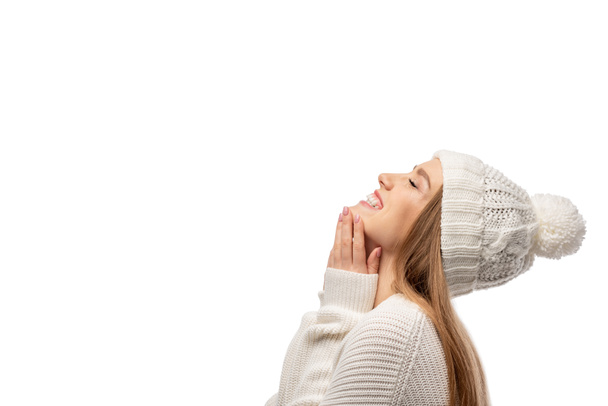 attractive cheerful woman posing in white knitted sweater and hat, isolated on white - Photo, Image