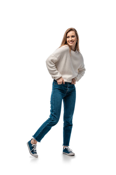 beautiful smiling woman in jeans and white sweater, isolated on white - Photo, Image