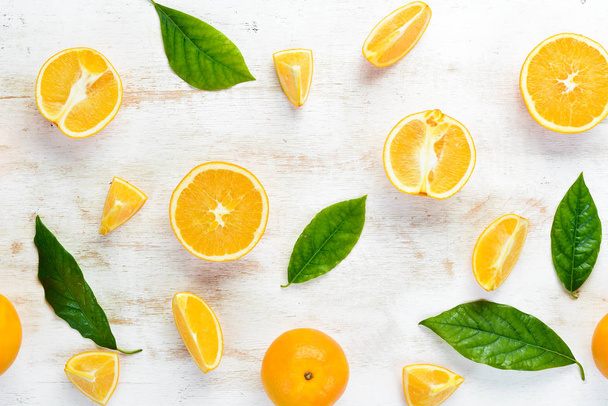 Fresh oranges with leaves. Citrus fruits on stone background. Top view. Free copy space. - Photo, Image