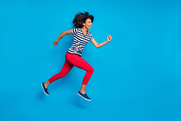 Side profile full length body size photo of cheerful laughing cute nice pretty girlfriend jumping running towards shopping center isolated vivid blue color background - Φωτογραφία, εικόνα