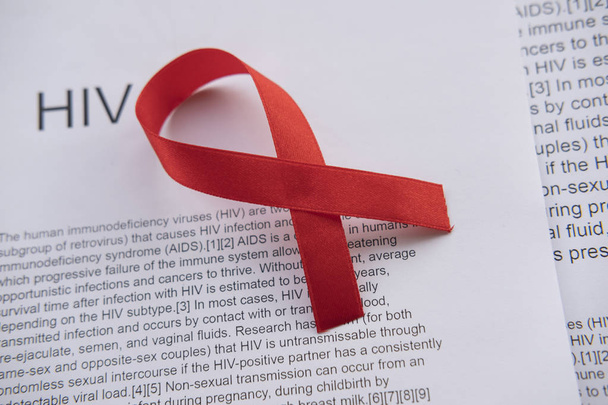 Red ribbon as a sign of HIV in laboratory scenery. Medical life. - Фото, изображение