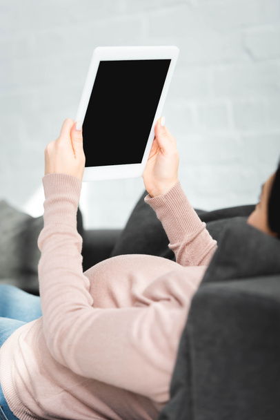 pregnant girl having online consultation with doctor on digital tablet with blank screen - Photo, image
