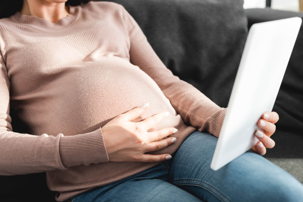 cropped view of pregnant woman having online consultation with doctor on digital tablet at home - Zdjęcie, obraz