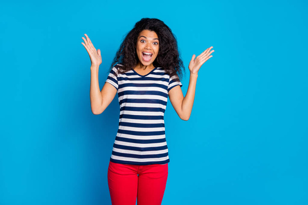 Photo of cheerful positive nice pretty sweet girlfriend smiling toothily screaming crazy expressing rejoicing emotions on face in striped t-shirt isolated vivid blue color background - Фото, зображення