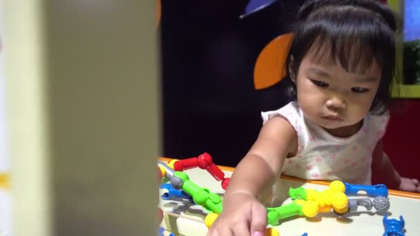 cute little Asian girl playing in child room - Кадри, відео