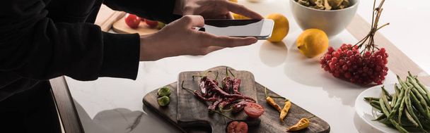 cropped view of photographer making food composition for commercial photography on smartphone - Photo, Image