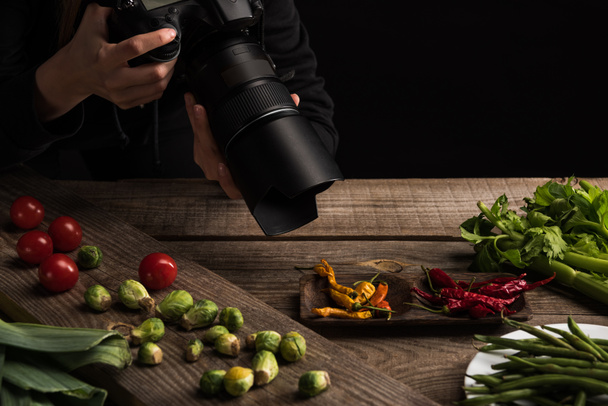 cropped view of female photographer making food composition for commercial photography and taking photo on digital camera  - Photo, Image